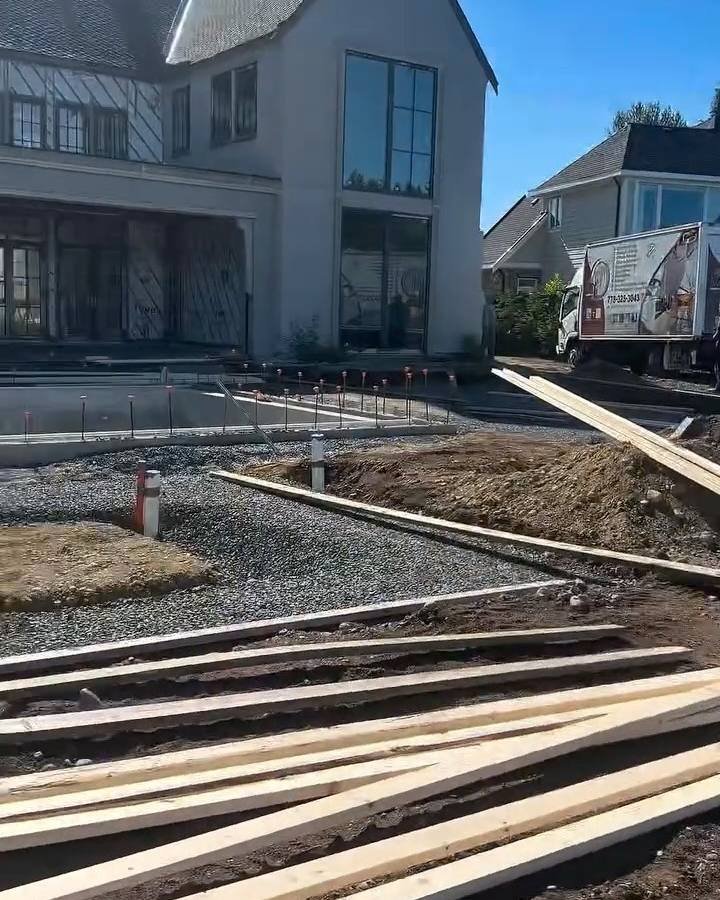 Forms and base prep for off-form concrete walls in front of a new house in Langley